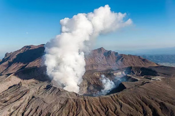 A smoke coming out of a crater Description automatically generated