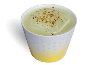 A cup of liquid with a sprinkle of flakes

Description automatically generated