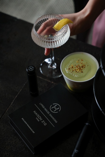 A person holding a glass of drink

Description automatically generated