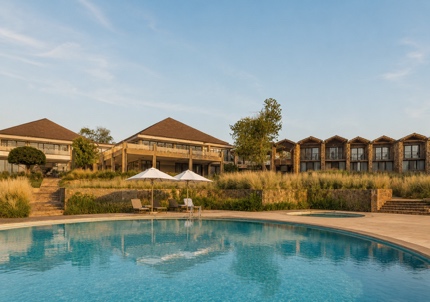 A swimming pool with a building in the background AI-generated content may be incorrect.